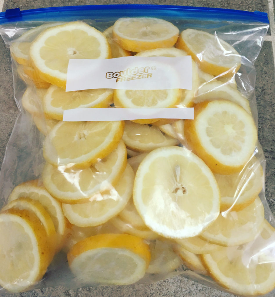 gallon size freezer bag filled with frozen lemon slices