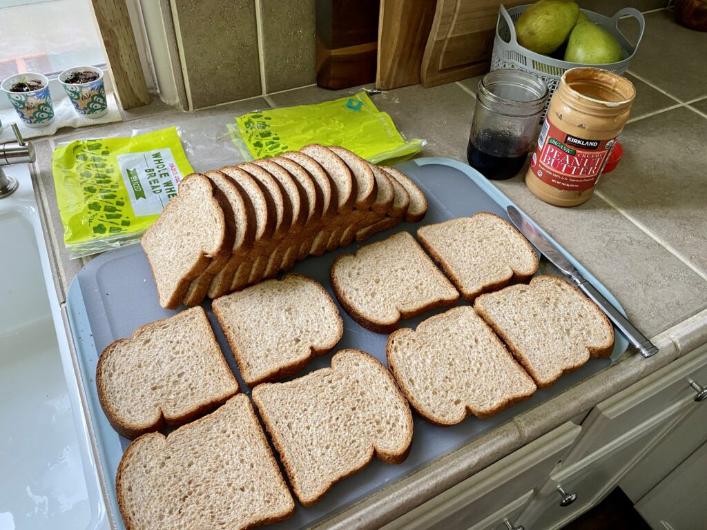 loaf of Trader Joe's sandwich bread making peanut butter and jelly sandwiches