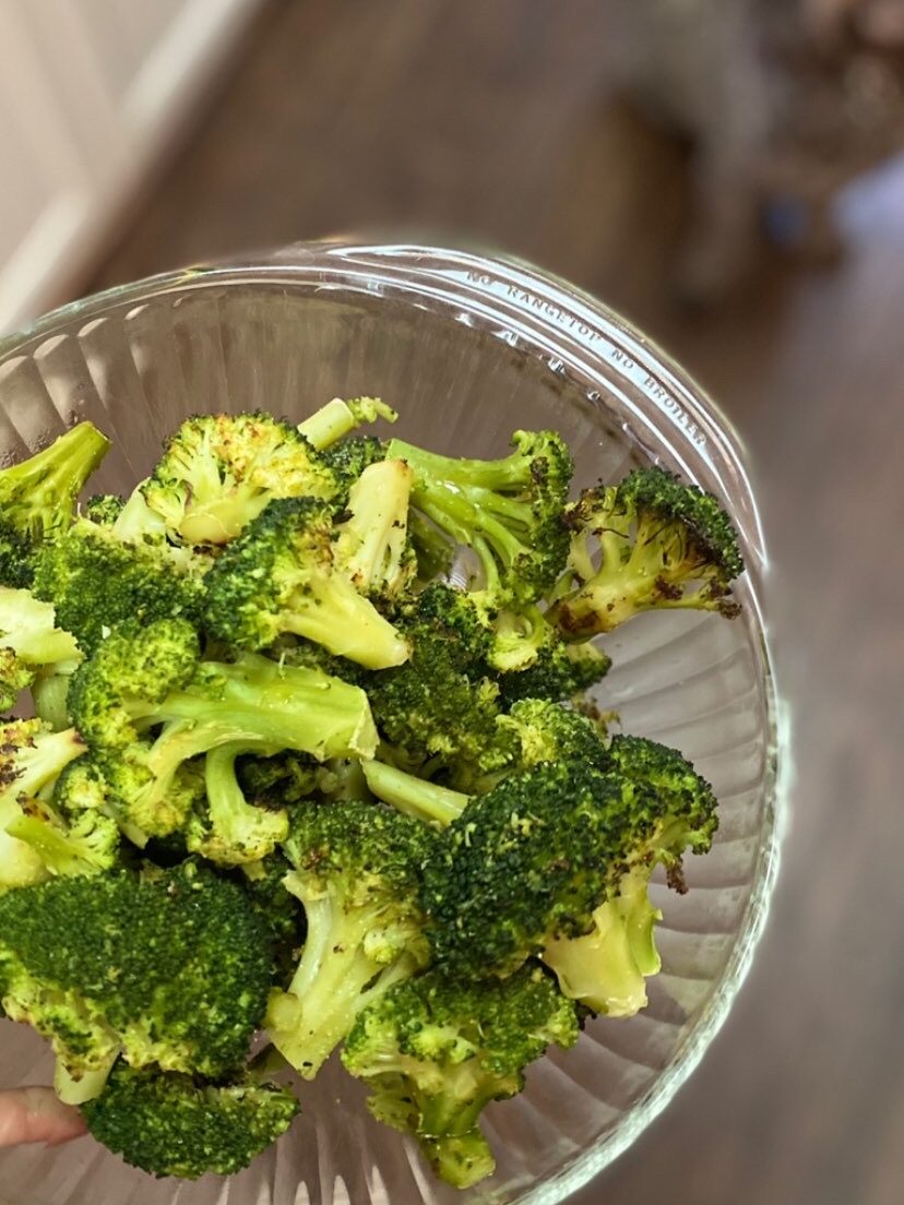 glass dish filled with roasted broccoli