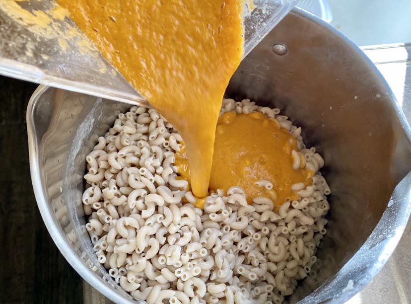 adding plant based queso to macaroni