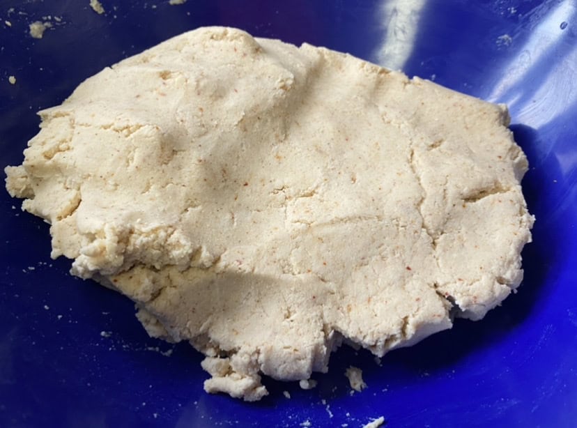 blue bowl filled with corn tortilla dough