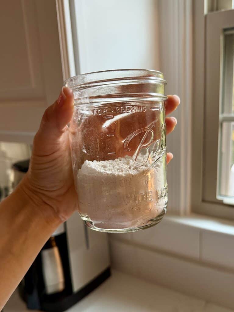 Aimee from Homemaker on a Budget measures flour for a flaky pie crust.