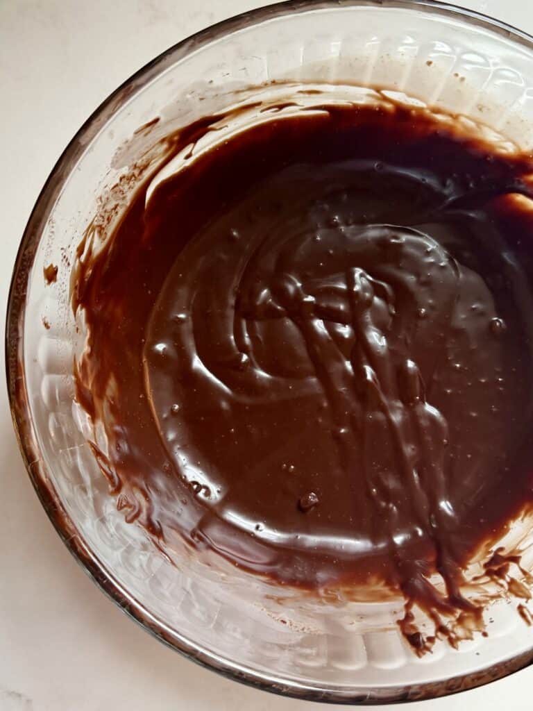 Aimee from Homemaker On a Budget makes a velvety chocolate ganache topping for a chocolate Pumpkin pie.