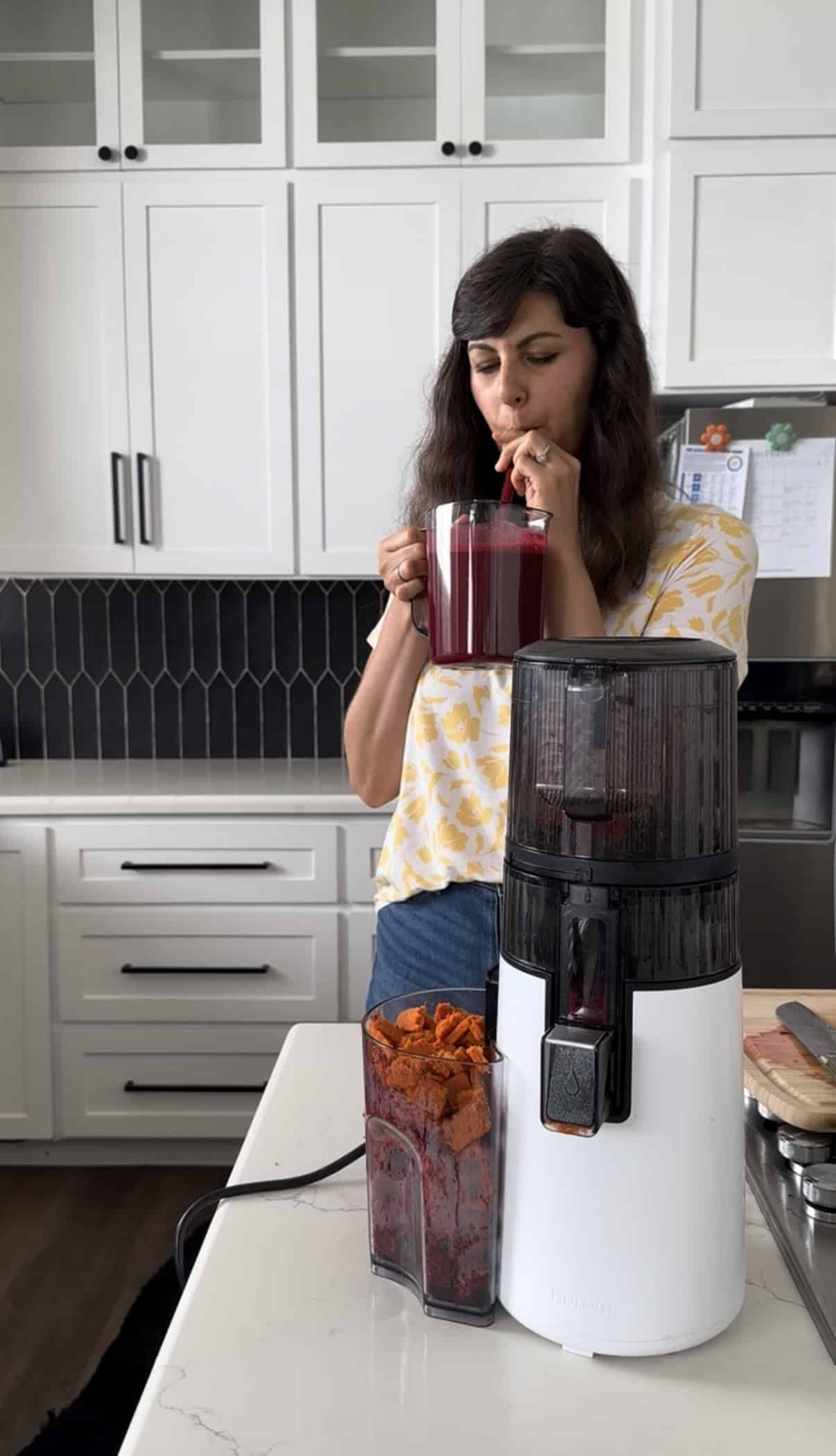 Aimee from Homemaker on a Budget samples beet, carrot, apple juice from Hurom H70 juicer.