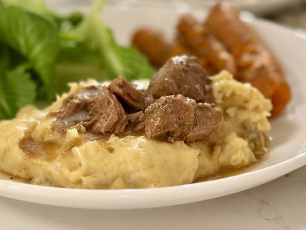 Aimee from Homemaker on a Budget serves up warm beef stew with mashed potatoes from the Instant Pot.