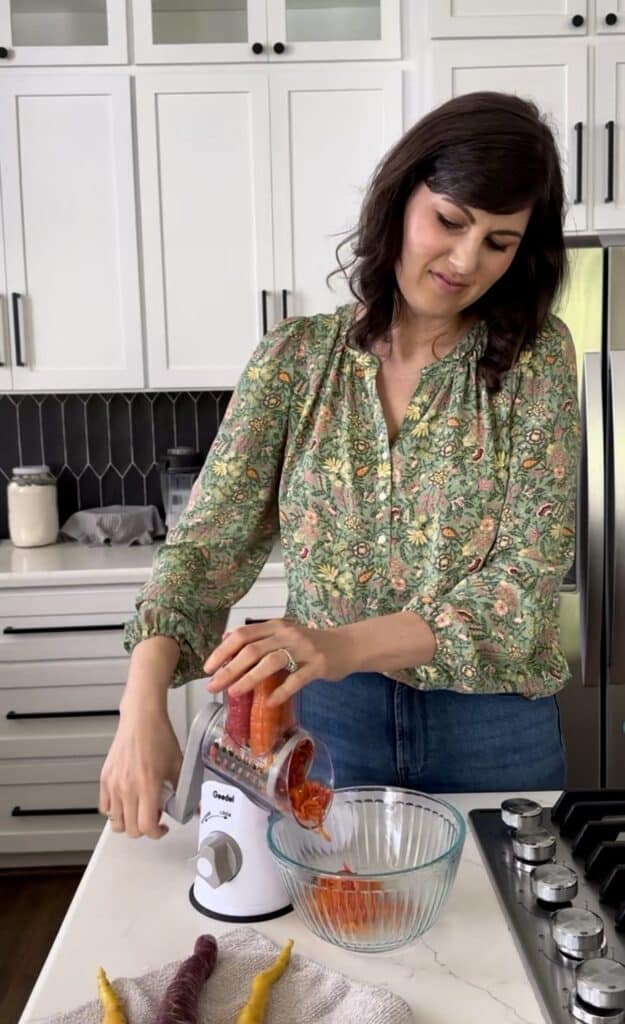 Aimee from Homemaker on a Budget uses a food processor to prepare homemade carrot cake snack bars.