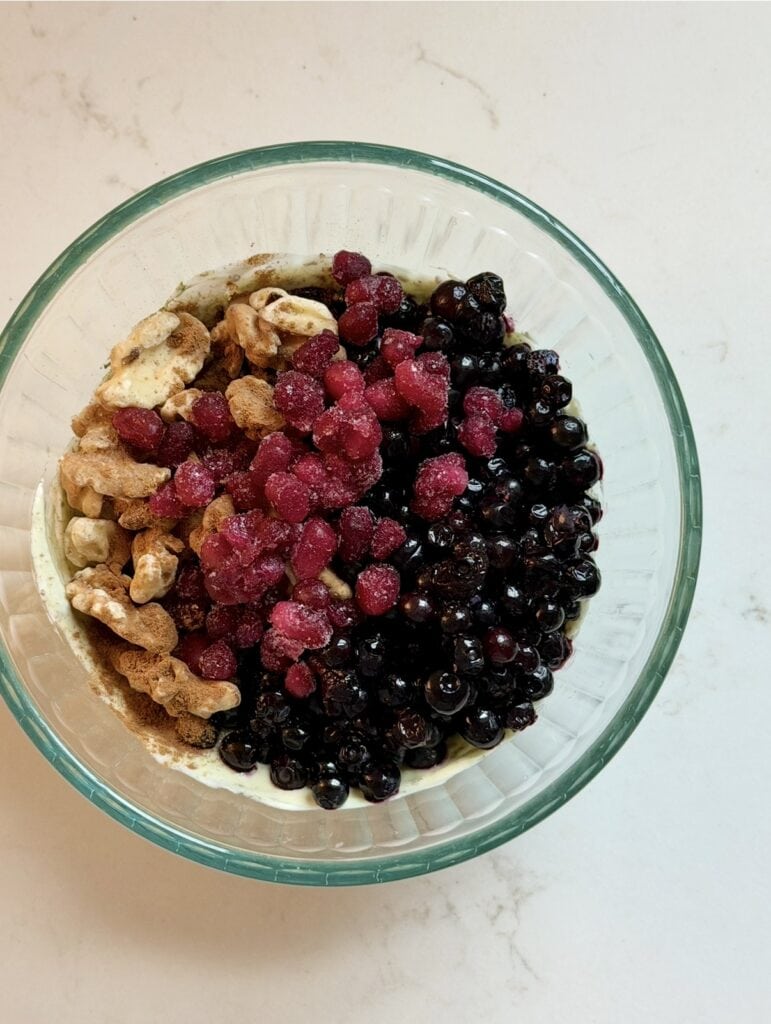 Aimee from Homemaker on a Budget tops Greek yogurt bowl with berries and walnuts for breakfast.