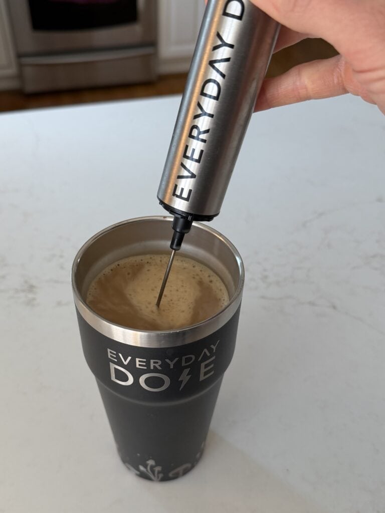 making everyday dose coffee in their travel mug