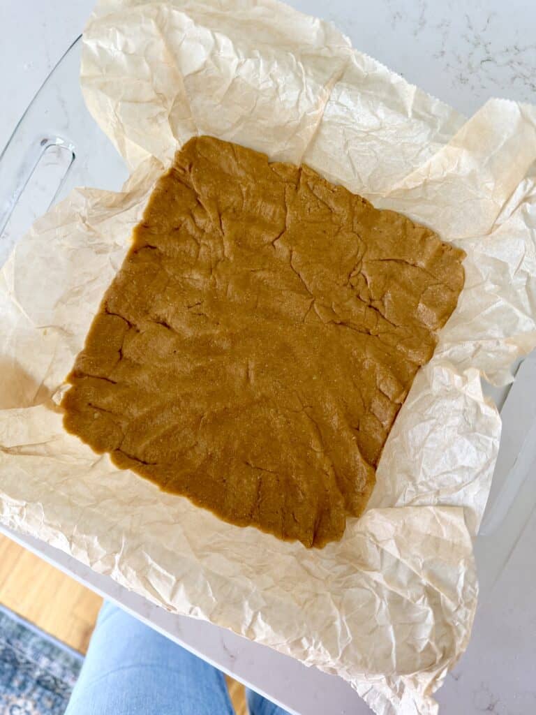 Aimee from Homemaker on a Budget makes the base of healthy no-bake buckeye bar recipe.