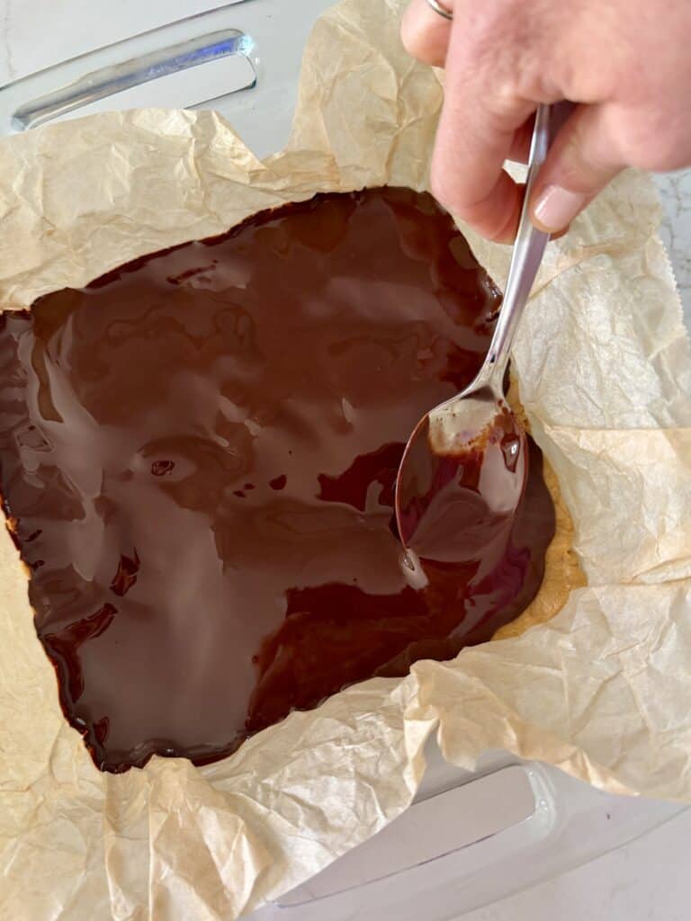 Aimee from Homemaker on a Budget prepares to chill a healthy no-bake buckeye bar recipe.