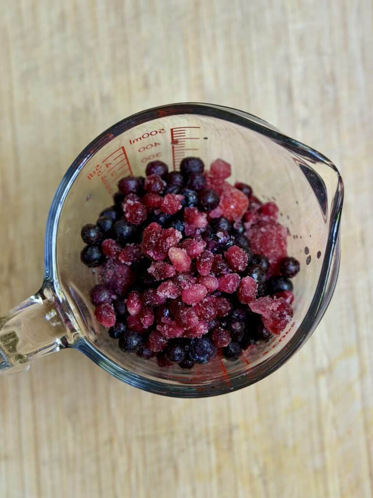 Aimee from Homemaker on a Budget prepares berries for an anti-inflammatory blueberry strawberry smoothie to start her day!