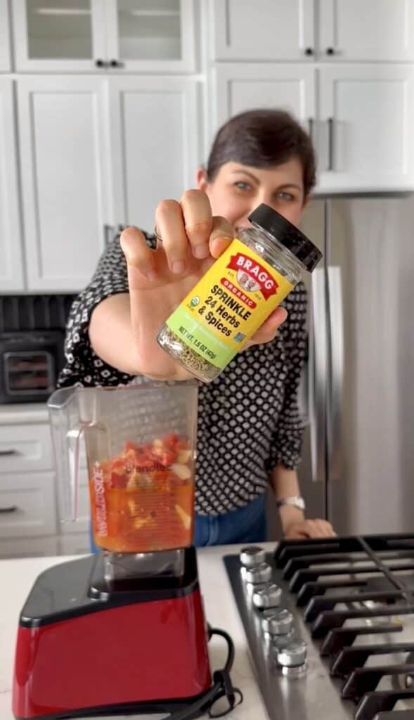 Aimee from Homemaker on a Budget seasons Roma tomatoes in homemade marinara sauce.