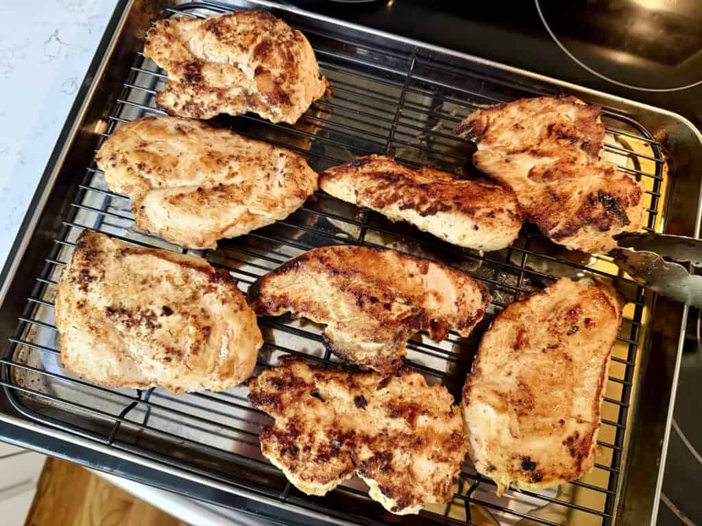 grilled chicken on a platter that's been marinaded in apple cider vinegar