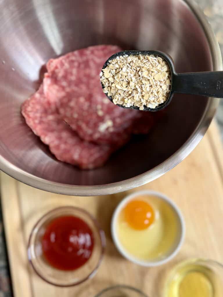 Aimee from Homemaker on a Budget mixes ingredients to create a homemade meatballs mix.