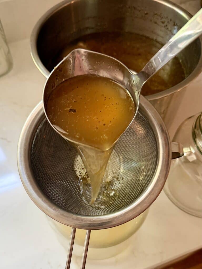 Aimee from Homemaker on a Budget shows us how to strain beef marrow bone broth to maximize nutrient intake.