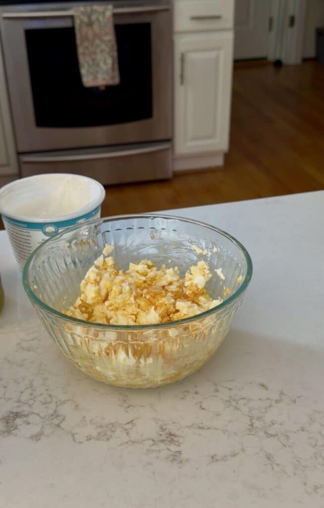 Aimee from Homemaker on a Budget smashes boiled eggs to create the perfectly textured base to curried egg salad.
