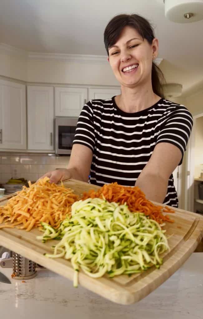 Aimee from Homemaker on a Budget prepares shredded vegetables for creamy sweet potato hamburger soup. 