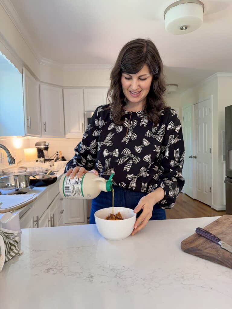 Aimee from Homemaker on a Budget adds maple syrup to pumpkin puree as she makes an easy homemade pumpkin butter recipe.