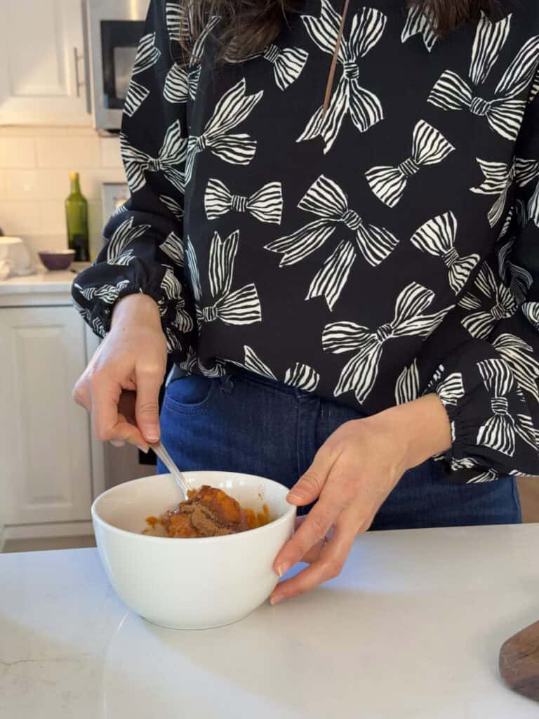 Aimee from Homemaker on a Budget mixes warm pie spices and salt to finish her homemade pumpkin butter recipe.