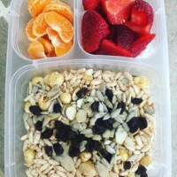puffed rice and corn cereal with sunflower seeds, slivered almonds, and raisins, strawberries and cutie orange. Milk provided at school