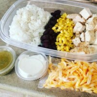 burrito bowl: rice, black beans, corn, chicken, with shredded cheese, salsa and sour cream