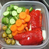 broiled bell pepper wrap with salami and cheese, carrots and cucumbers, green olives