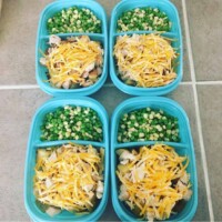 roasted potatoes topped with shredded chicken and cheese, side of corn and peas