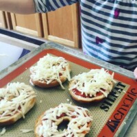 gluten-free bagels topped with pizza sauce and mozzarella cheese. Baked 400 degrees until cheese melts