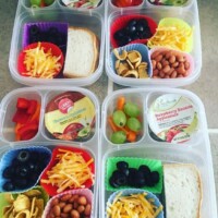nacho plates with pinto beans, fritos, cheese, olives, bell pepper, applesauce